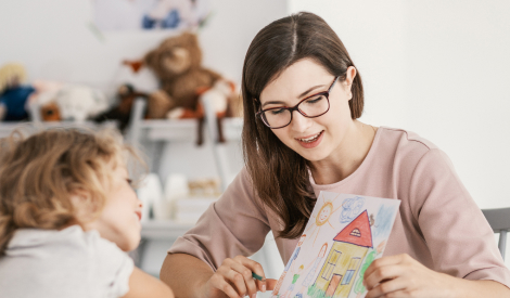 mom showing a drawing to a little girl