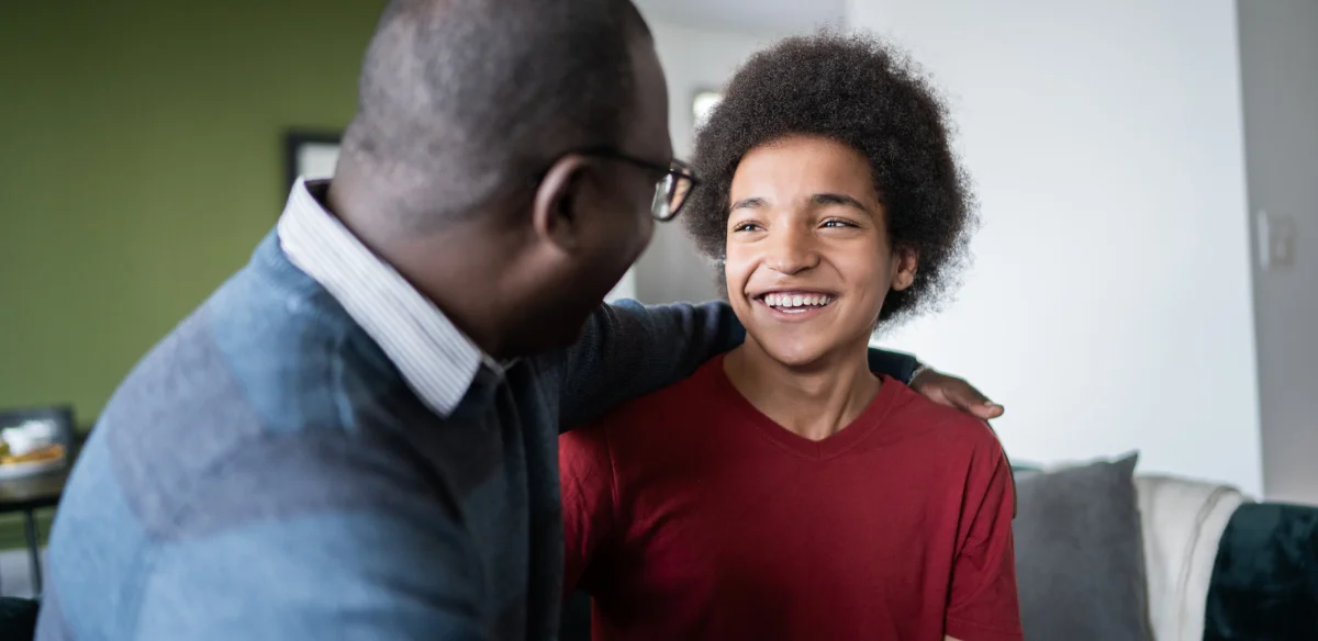 dad and son looking each other and smiling