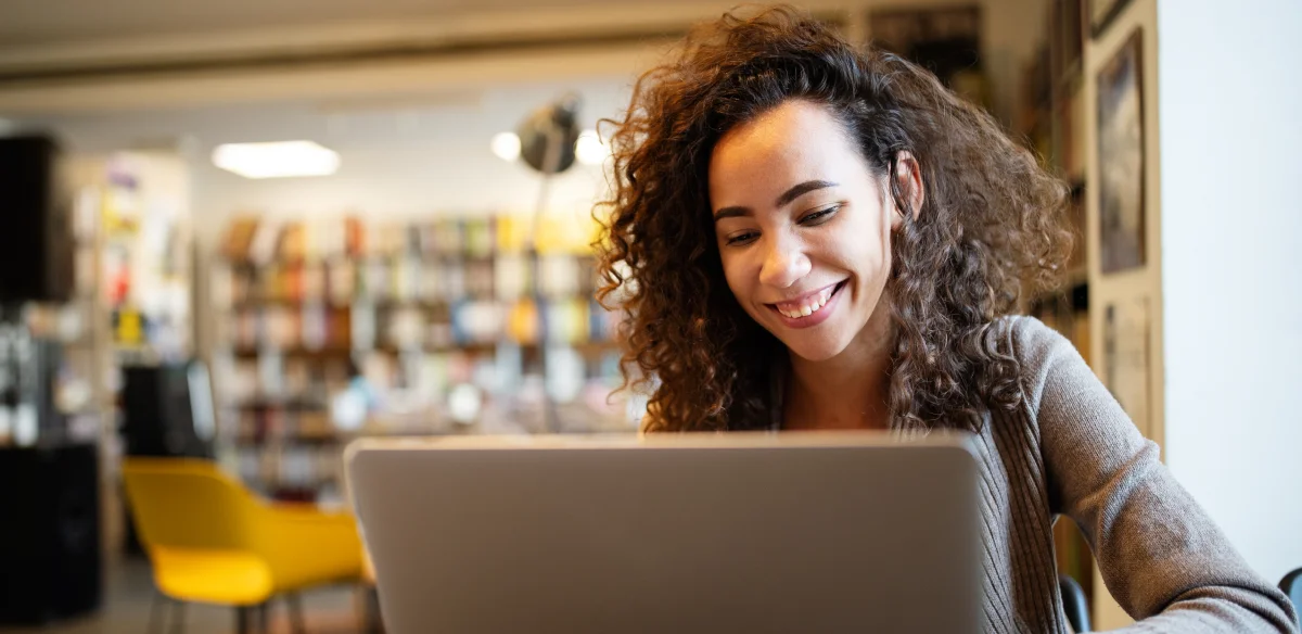 woman smiling with computer